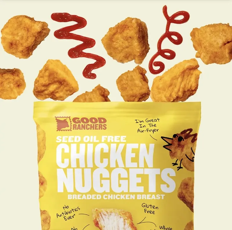 Chicken nuggets and ketchup bursting out of a Good Ranchers Chicken Nuggets bag