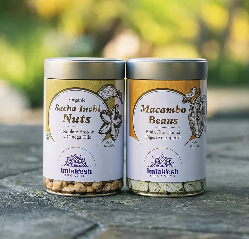 Imlak'esh Organics Sacha Inchi Nuts and Macambo Beans tins outdoors