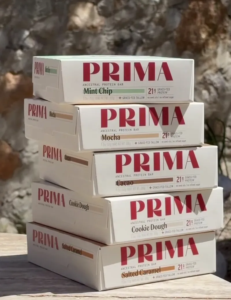 A stack of five Prima Ancestral Protein Bar boxes in the sun